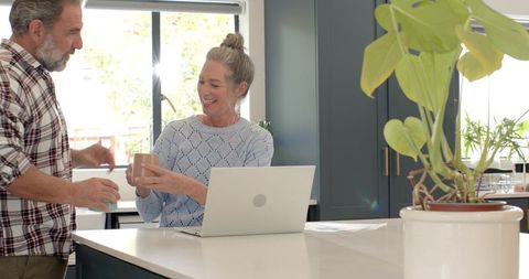 Senior Couple Enjoying Morning Coffee at Modern Kitchen Island