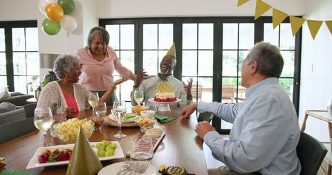 Senior Friends Celebrating Birthday with Joyful Candles