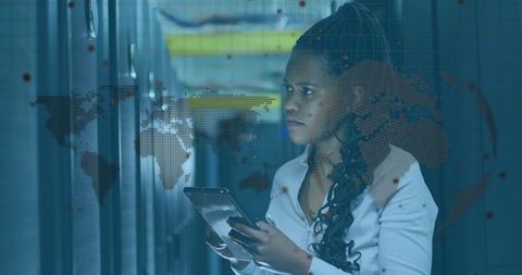 Engineer Analyzing Data in Server Room with World Map Overlay