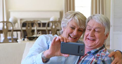 Senior Couple Taking a Selfie in Comfortable Living Room