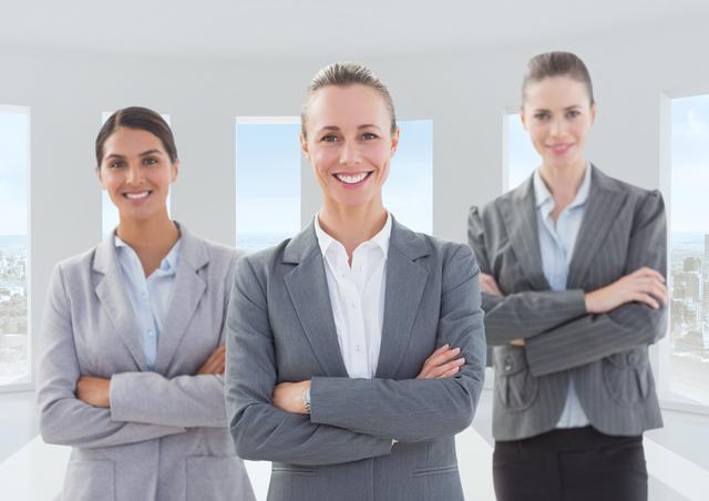 Three confident female executives posing with arms crossed in a modern, bright office environment, showcasing professionalism, leadership, and team spirit. Useful for business, corporate teamwork, women's leadership, and professional networking concepts.