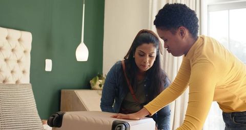 Two Women Packing Suitcase Hotel Room Travel Friendship Vivid Interior
