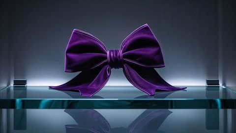 Luxurious purple velvet bow on glass shelf with led glow