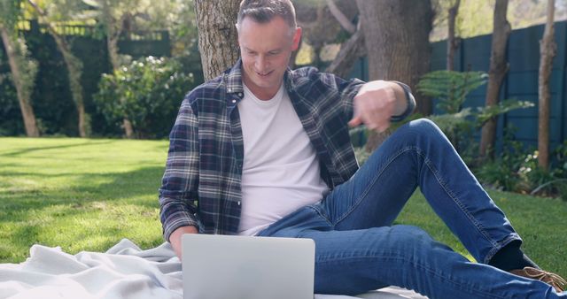 Man Relaxing with Laptop on Grass in Sunny Park - Download Free Stock Images Pikwizard.com