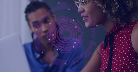 Tech team analyzing digital data graphic on laptop