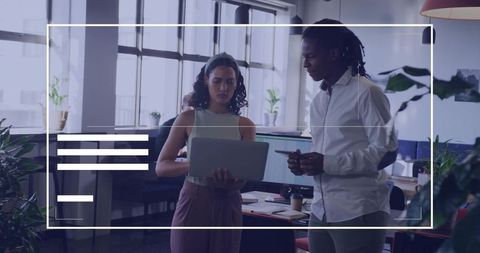 Collaborating Professionals Discussing Project on Laptop in Modern Office