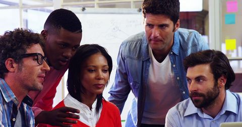 Diverse Business Team Collaborating Around Laptop