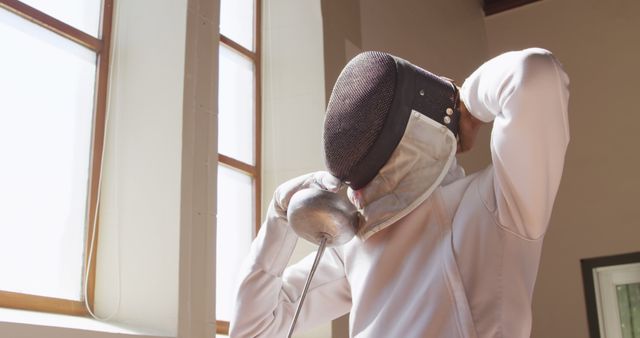 Fencer Preparing for Match in Sunlit Room - Download Free Stock Images Pikwizard.com