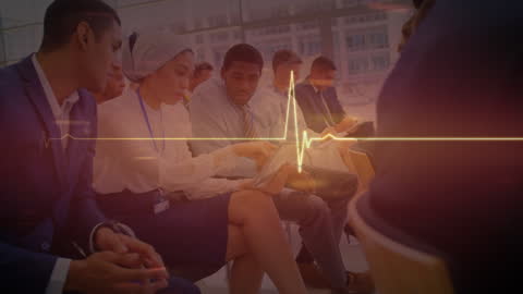 Diverse Business Group Analyzing Digital Tablet with ECG Overlay