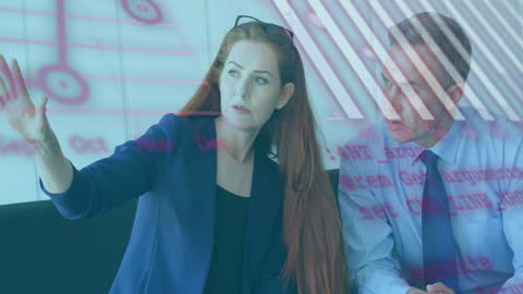 Business Colleagues Analyzing Data Projections in Office