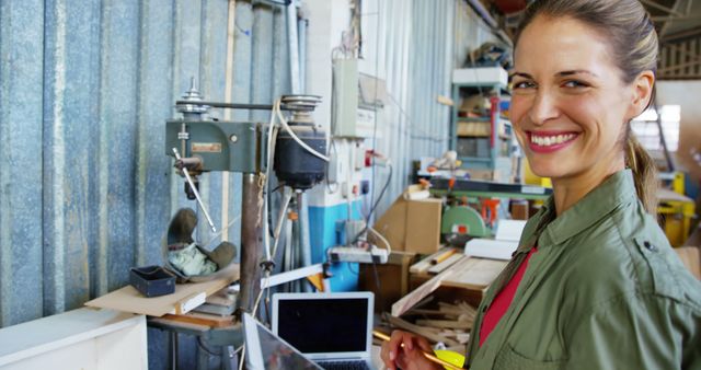 Female Carpenter Smiling in Workshop with Tools and Equipment - Download Free Stock Images Pikwizard.com