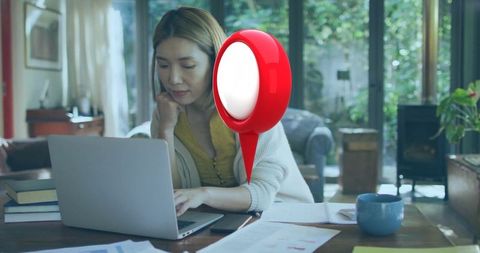 Chinese Woman Working on Laptop at Home in Cozy Environment