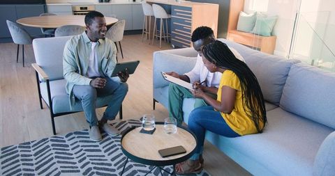 Friendly Gathering in Modern Living Room Welcomes Guest with Warm Smiles