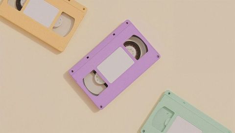 Colorful pastel vhs tapes on beige background for retro nostalgia theme