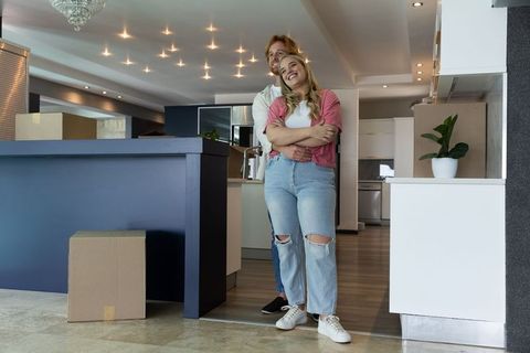 Couple Embracing in Modern Kitchen During Move-In