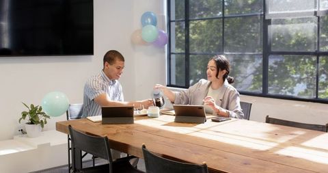Business colleagues celebrating birthday in modern office
