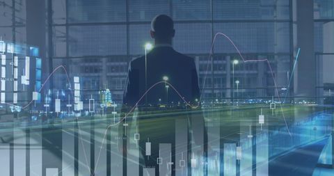 Businessman analyzing financial statistics at night