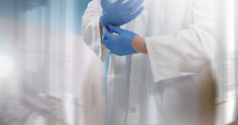 Surgeon preparing for medical procedure with gloves