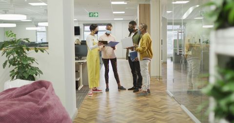 Colleagues Collaborating in Modern Office Post-Pandemic