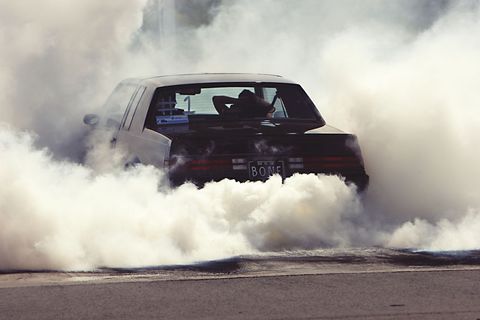 Car performing epic tire burnout in thick smoke