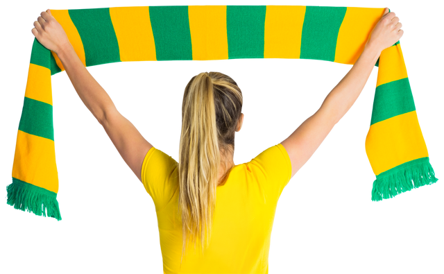 Woman holding green and yellow football scarf, showing support, arms raised in celebration - Download Free Stock Videos Pikwizard.com