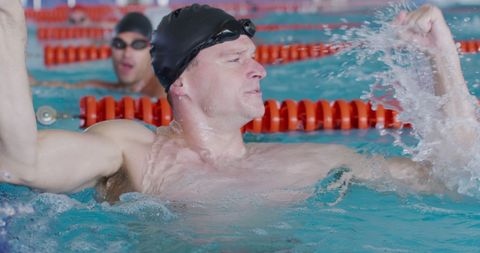 Victorious Swimmer Celebrating Achievement in Indoor Pool