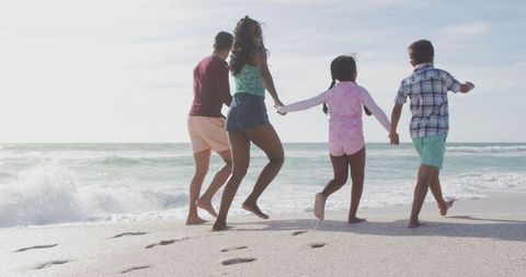 Family Walking Together on Sunny Beach Vacation