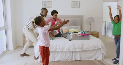 Family excitement packing for vacation in cozy bedroom