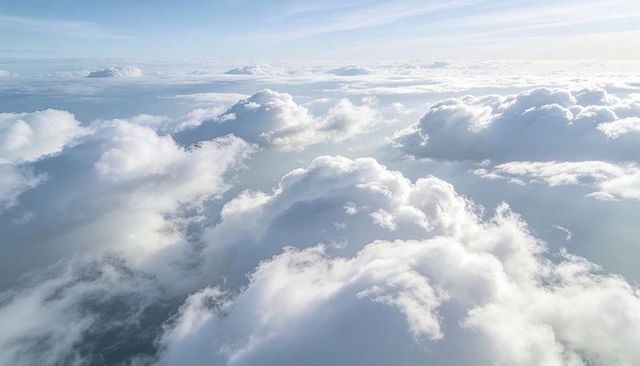 Sunlit Drifting Cumulus Cloudscape Over Vast Horizon, High Altitude Airy Atmosphere