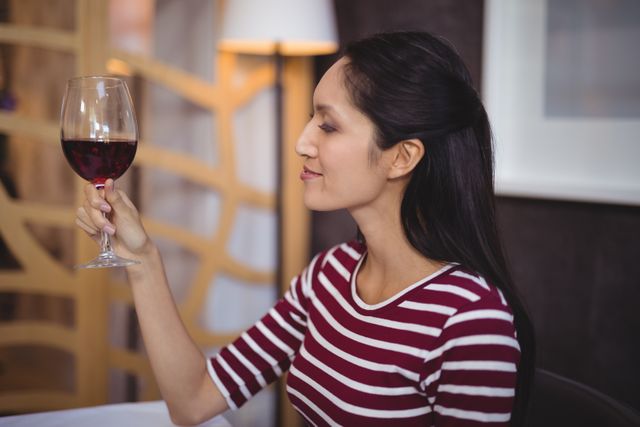 Woman having a glass of red wine in restaurant