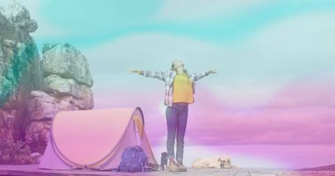 Woman enjoying scenic cliffside adventure with camping tent and pet dog