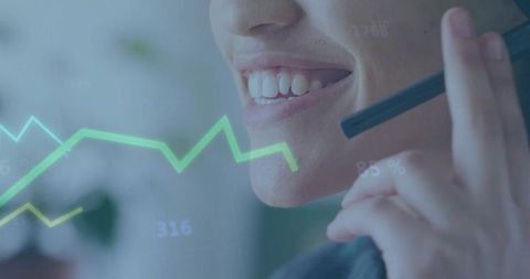 Smiling customer support agent holding headset mic speaking with green data chart overlay