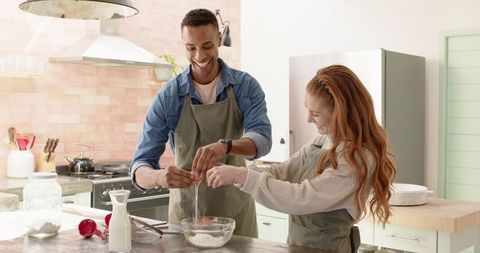 Smiling Couple Preparing Ingredients in Modern Kitchen
