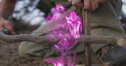 Primitive fire starting with bow drill and mysterious purple energy swirl