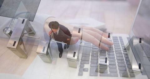 Businessman Walking Through Turnstiles with Laptop Overlay - Download Free Stock Images Pikwizard.com