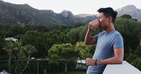 Man Enjoying Morning Coffee Overlooking Scenic Mountain View