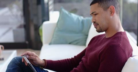 Modern Lounge: Using Tablet for Relaxation in Minimalist Living Room