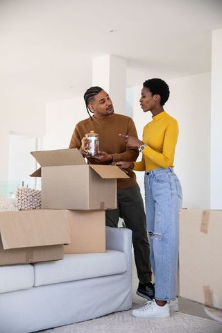 Couple unpacking in new home sharing joy and teamwork