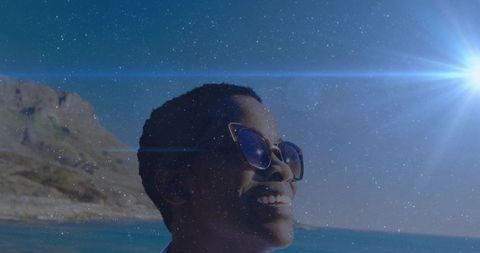 Smiling Woman in Sunglasses Enjoying Bright Sunny Day on Rocky Coastline