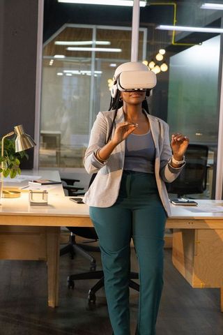 Businesswoman exploring virtual reality analytics in modern co-working office