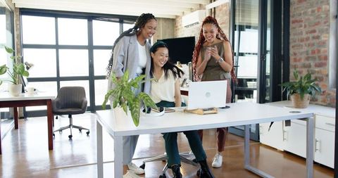 Diverse team celebrating success together in modern office