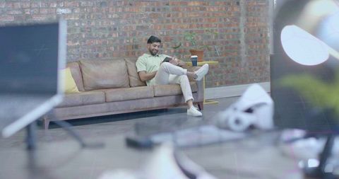 Tech-Savvy Professional Relaxing in Creative Office Lounge