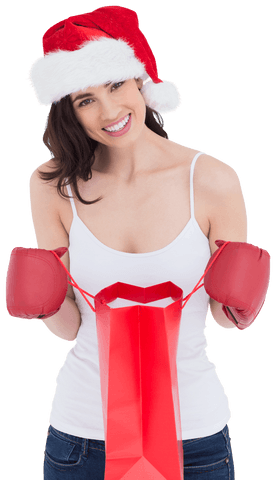 Festive woman with boxing gloves opening holiday gift bag transparent