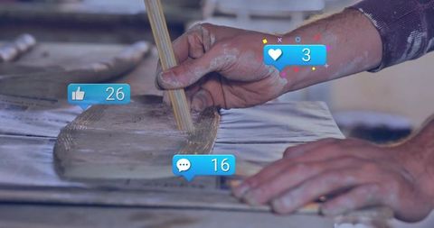Artisan crafting wooden surfboard with social media interaction