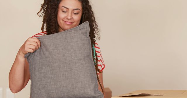 Woman Packing Grey Pillow During Move - Download Free Stock Images Pikwizard.com