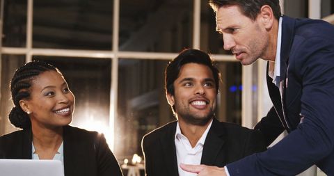 Diverse professionals engaging in positive office discussion