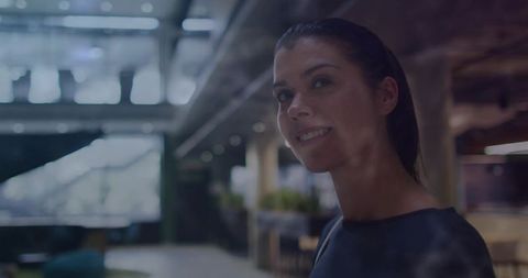 Confident Businesswoman in Modern Office with Glass Walls
