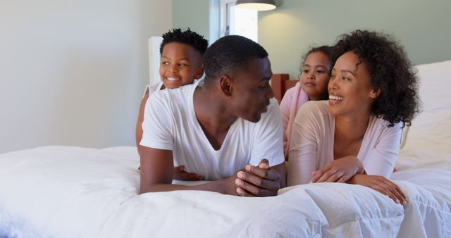 Happy African American Family Enjoying Quality Time in Cozy Bedroom - Download Free Stock Images Pikwizard.com