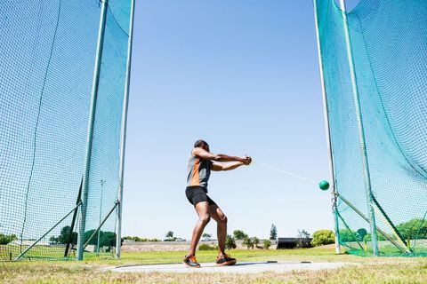 Athlete Executing Powerful Hammer Throw on Sunny Day - Download Free Stock Images Pikwizard.com