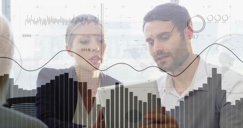 Business team reviewing data on tablet with digital analytics overlay